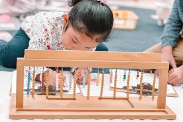 Primary student using the teens math rack.